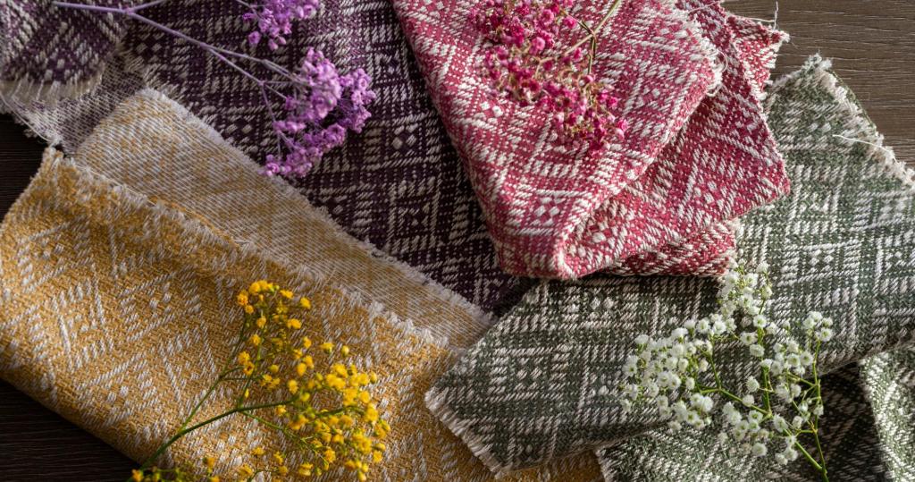 Pink, purple, yellow and green woven fabrics with matching flowers